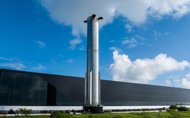 A huge Super Heavy booster is rolled onto the launch pad ahead of the launch of Starship Flight 8 by SpaceX